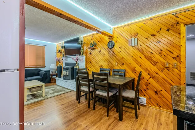 a dining room with furniture and wooden floor