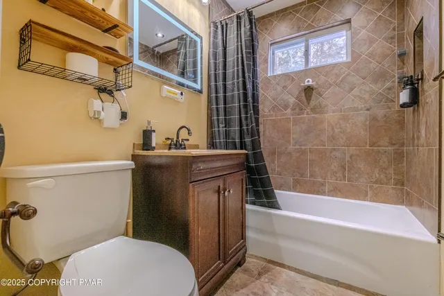 a bathroom with a sink a toilet and bathtub