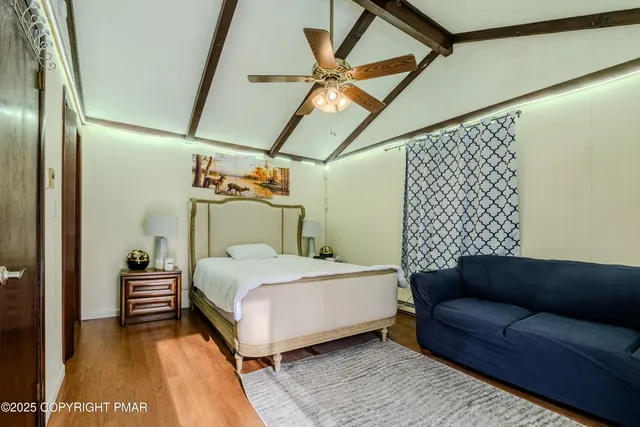 a bedroom with a bed couch and a window