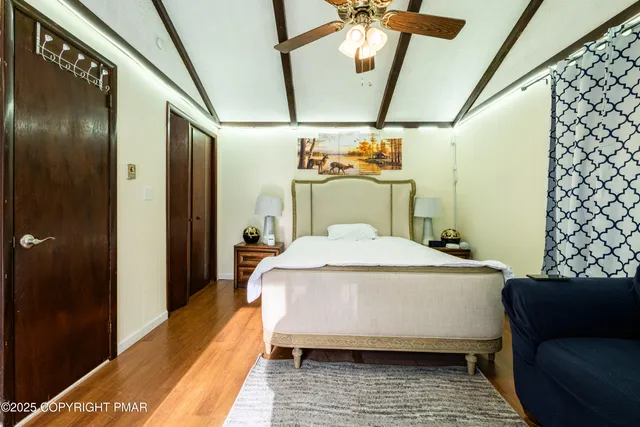 a bedroom with a bed and a mirror