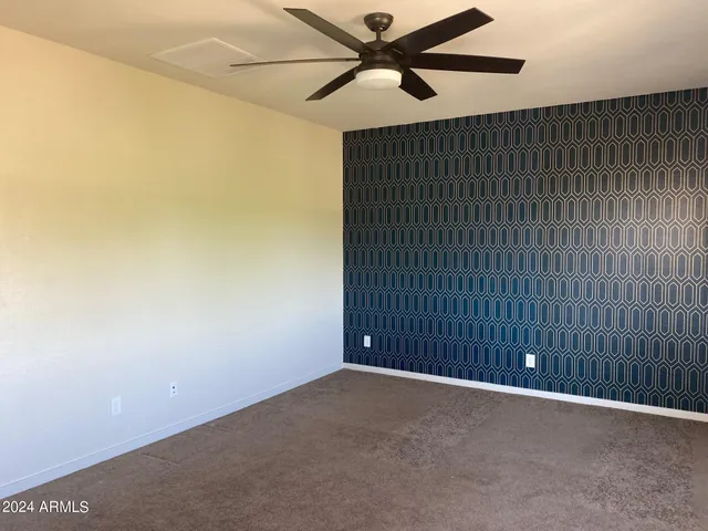 a view of an empty room with a fan