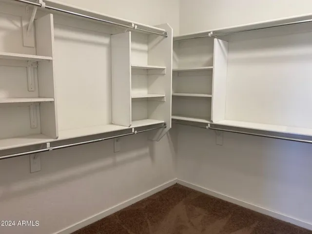 a room with walk in closet and window