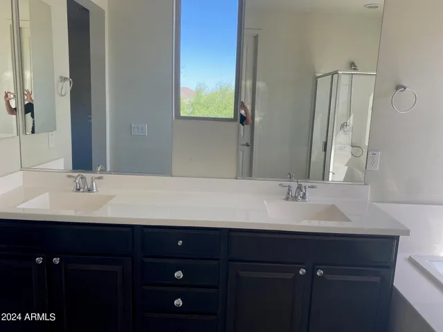 a bathroom with a double vanity sink and mirror