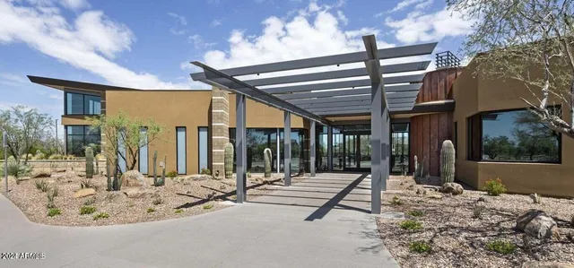 a view of a swimming pool with furniture