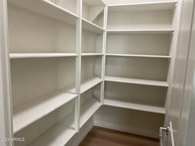 a view of walk in closet with empty racks