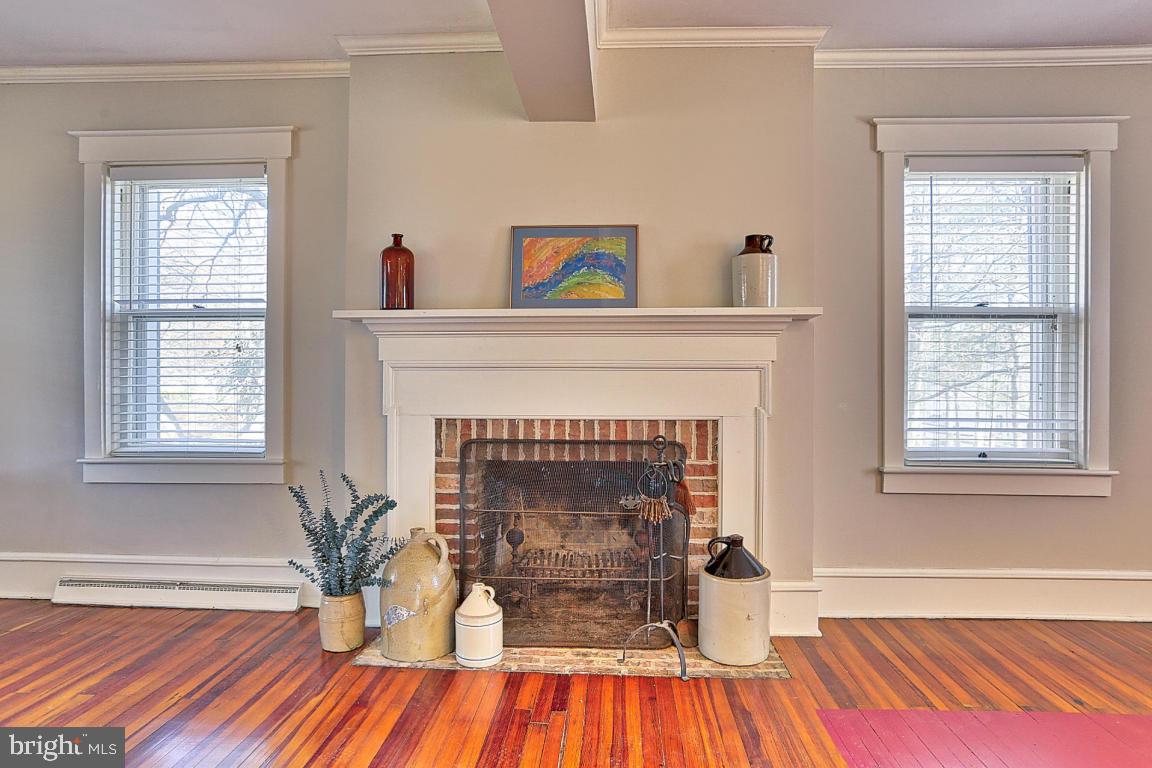 181 Windover Turn Lancaster, PA 17601 - Photo 12 of 58 a living room with a fireplace and wooden floor