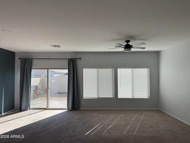 an empty room with a empty space and windows