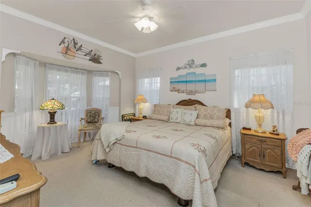a bedroom with a bed and a white cabinet