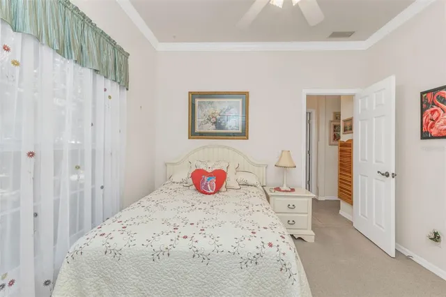 a living room with furniture and large windows