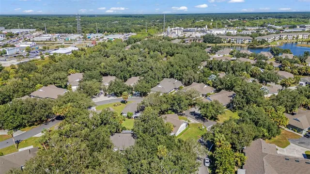an aerial view of a house with outdoor space and a swimming pool