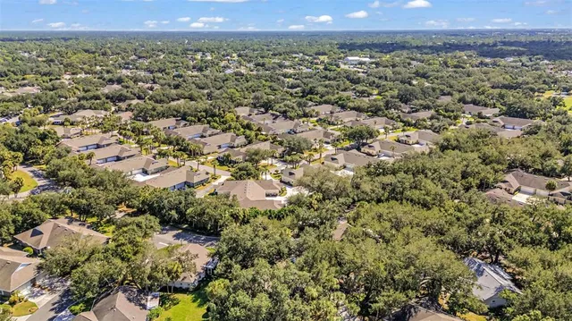a view of a patio with a table chairs and a floor to ceiling window