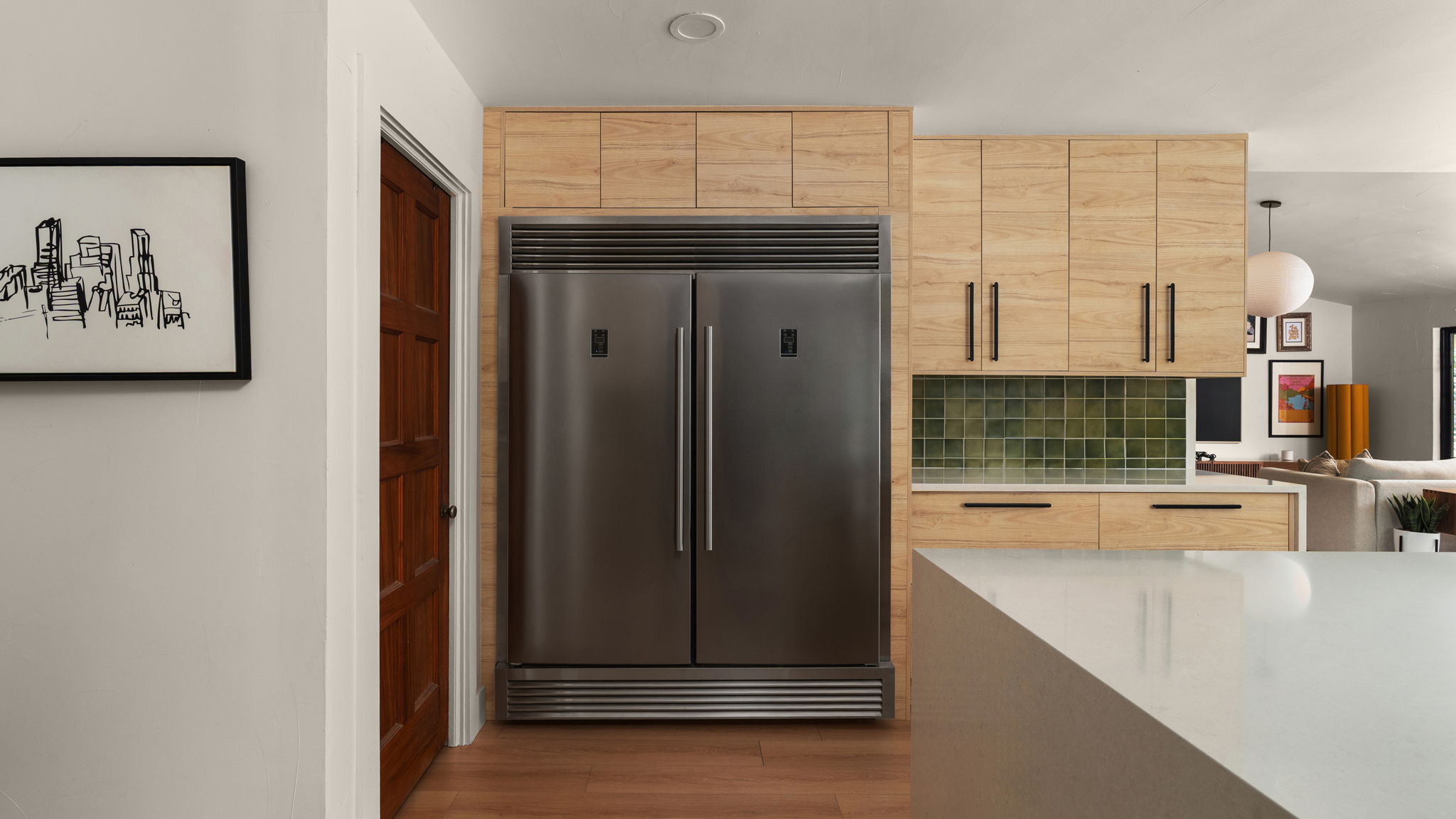 404 Whitetail Drive Manchaca, TX 78652 - Photo 11 of 33 Kitchen featuring light wood finish cabinets, stainless steel built in refrigerator, dark wood-style flooring, light stone countertops, and decorative backsplash