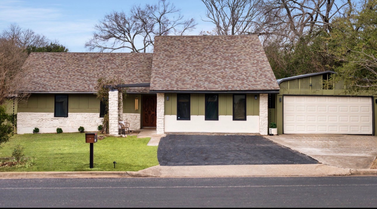 404 Whitetail Drive Manchaca, TX 78652 - Photo 2 of 33 View of front facade with driveway, a front lawn, roof with shingles, and stone siding