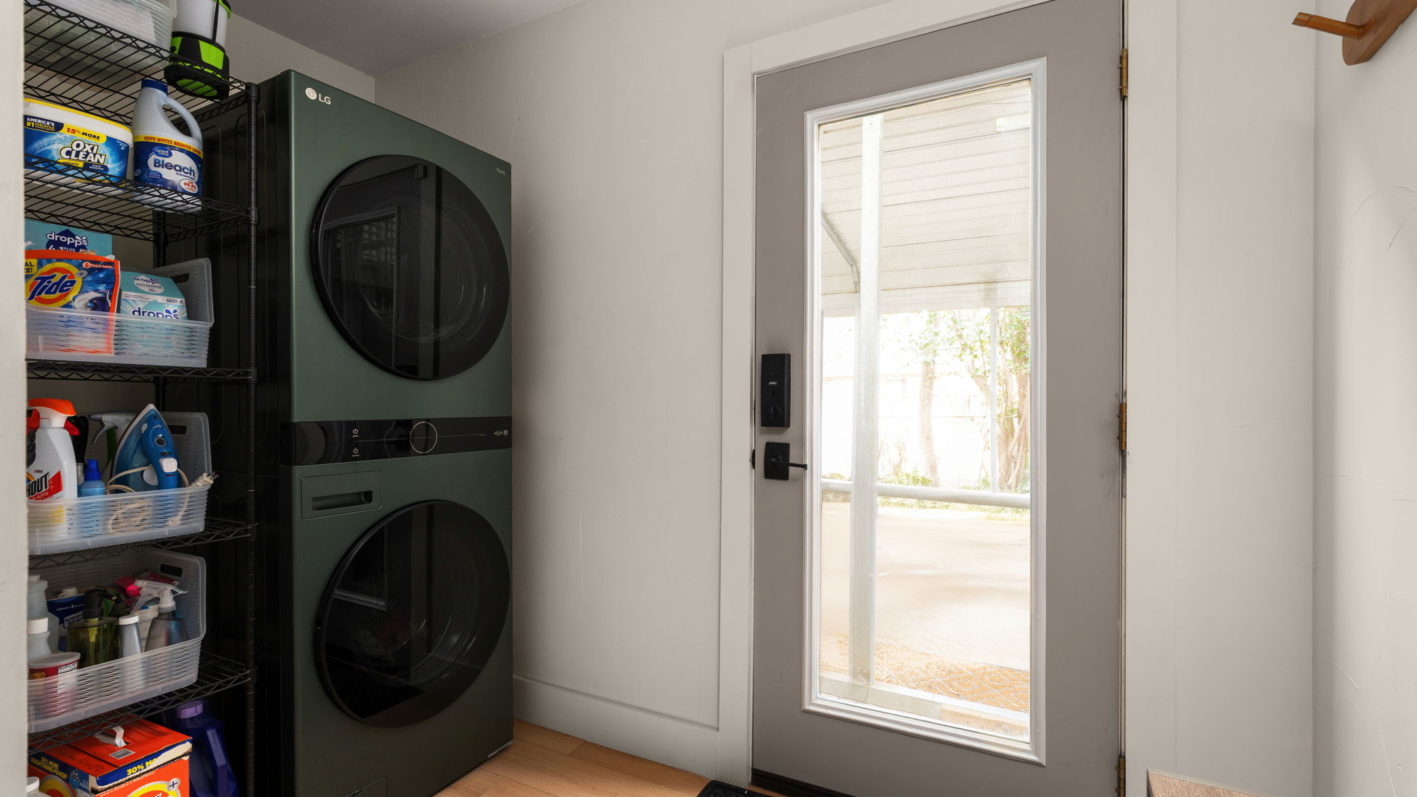 404 Whitetail Drive Manchaca, TX 78652 - Photo 24 of 33 Laundry room featuring stacked washer and clothes dryer and wood finished floors