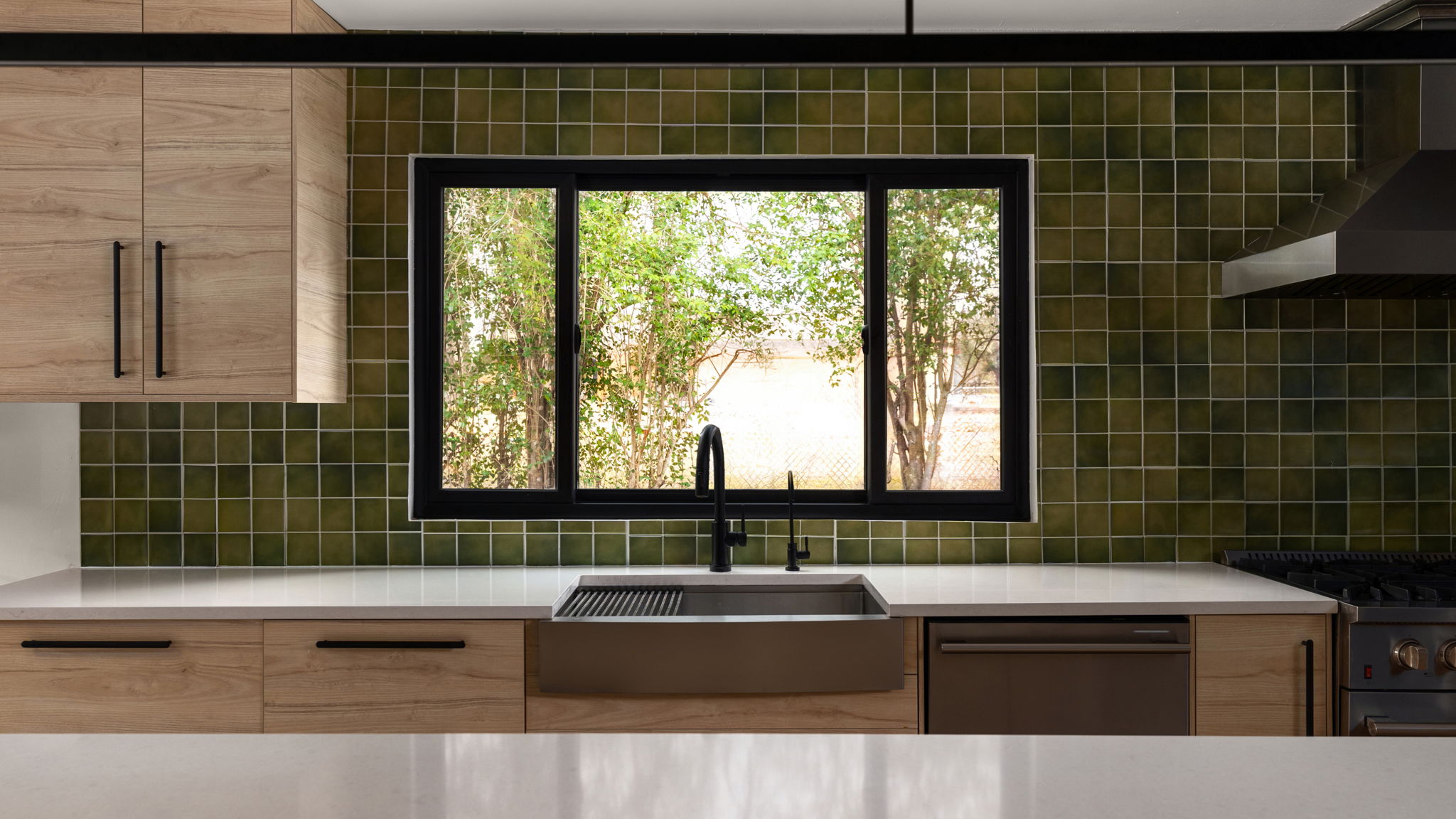 404 Whitetail Drive Manchaca, TX 78652 - Photo 8 of 33 Kitchen featuring light wood finish cabinets, stainless steel appliances, backsplash, and modern cabinets