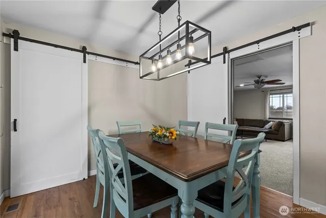 a view of a dining room with furniture and wooden floor