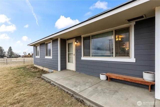 a view of backyard with a barbeque grill and wooden fence