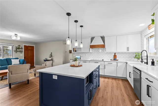 a kitchen with a sink cabinets and wooden floor