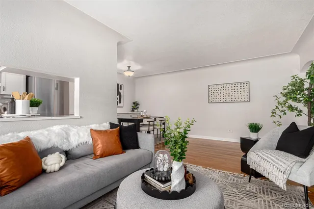 a living room with furniture and flowers