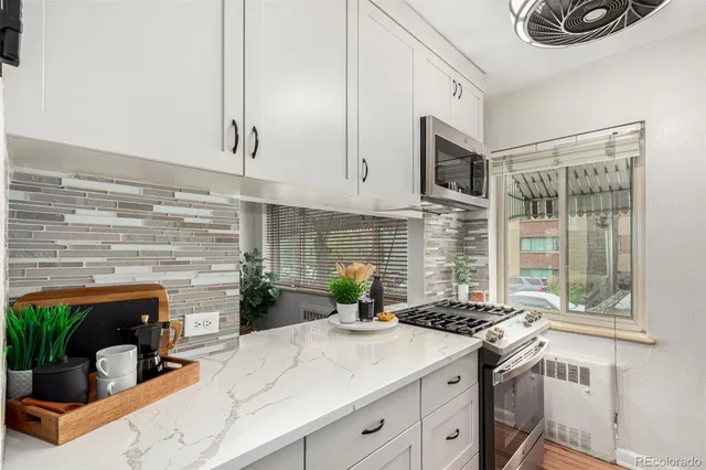 a kitchen with a stove a sink and a microwave