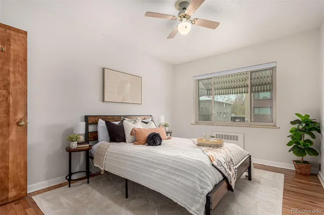 a bedroom with a large bed and a potted plant