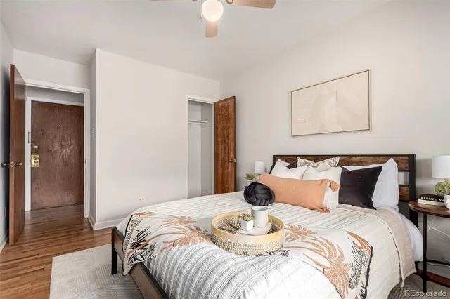 a bedroom with bed and wooden floor