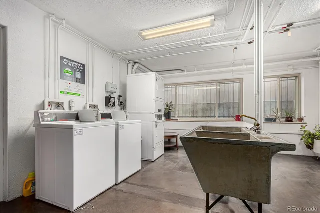 a kitchen with kitchen island sink stove and white cabinets