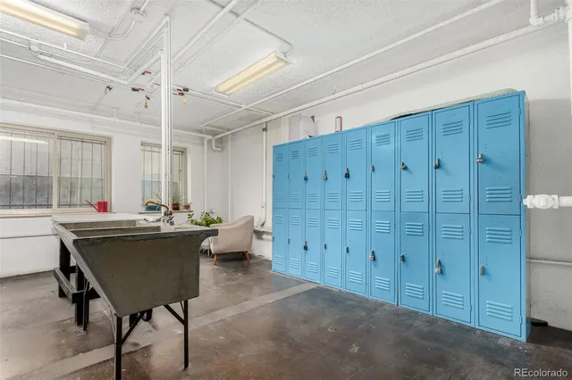 a view of a workspace with furniture and window