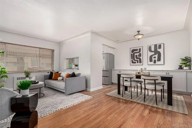 a living room with furniture dining area and a wooden floor