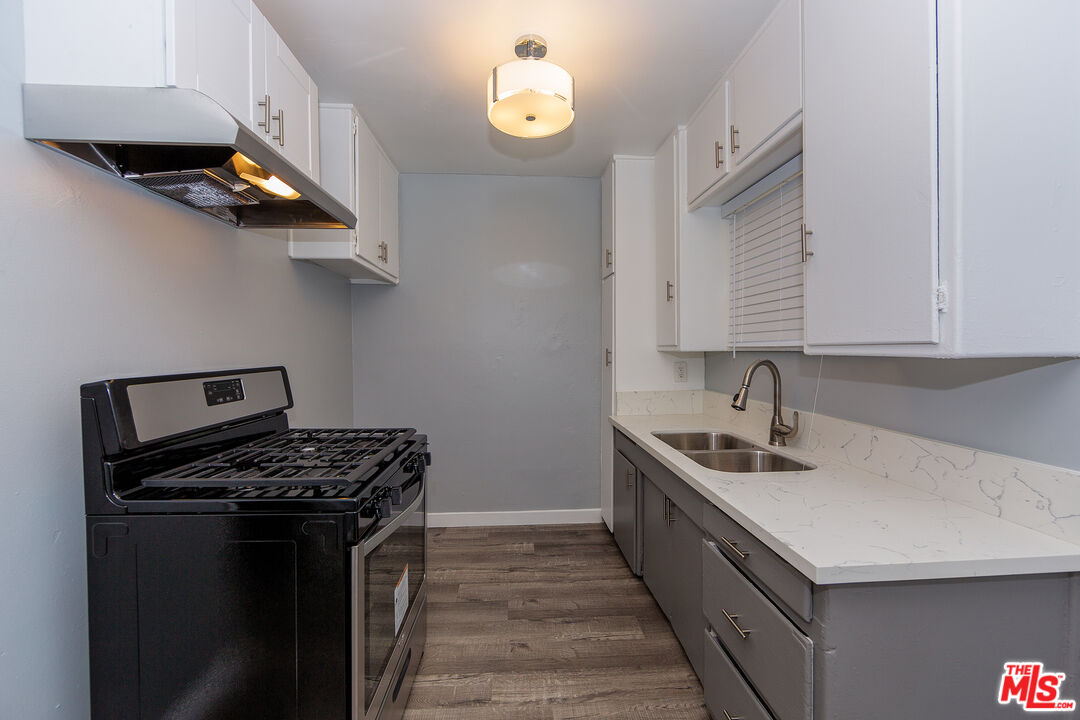 1430 Chestnut Avenue Long Beach, CA 90813 - Photo 9 of 11 a kitchen with stainless steel appliances granite countertop a sink stove and cabinets