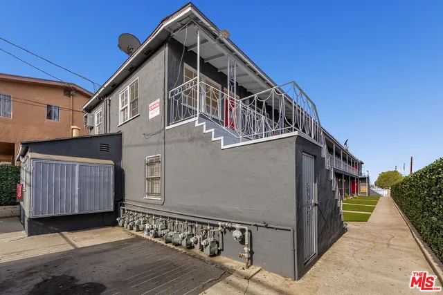 a view of a house with wooden fence