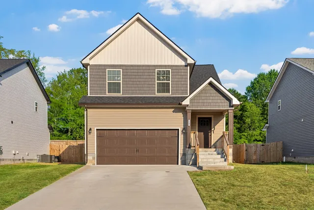 a front view of a house with a yard and garage
