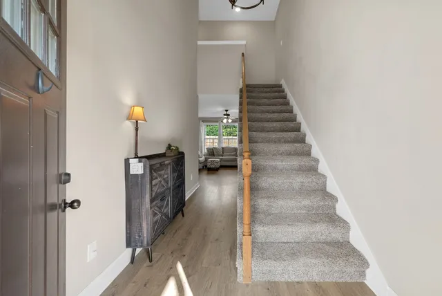 a view of entryway and hall with wooden floor