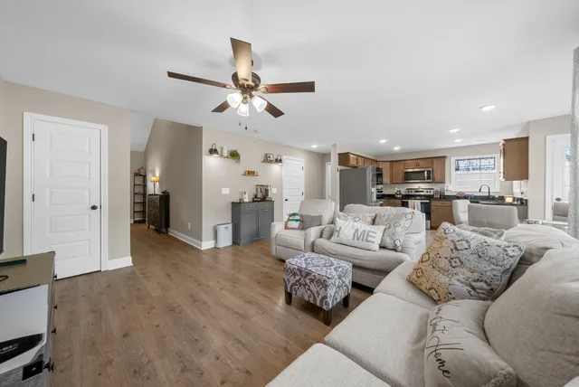 a living room with furniture and kitchen view