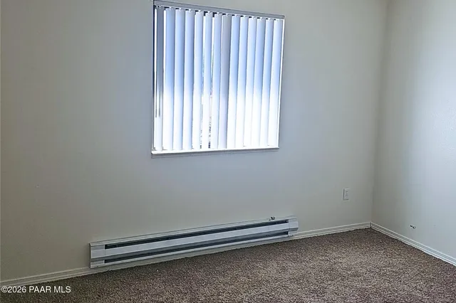 a room with a wooden floor and a window