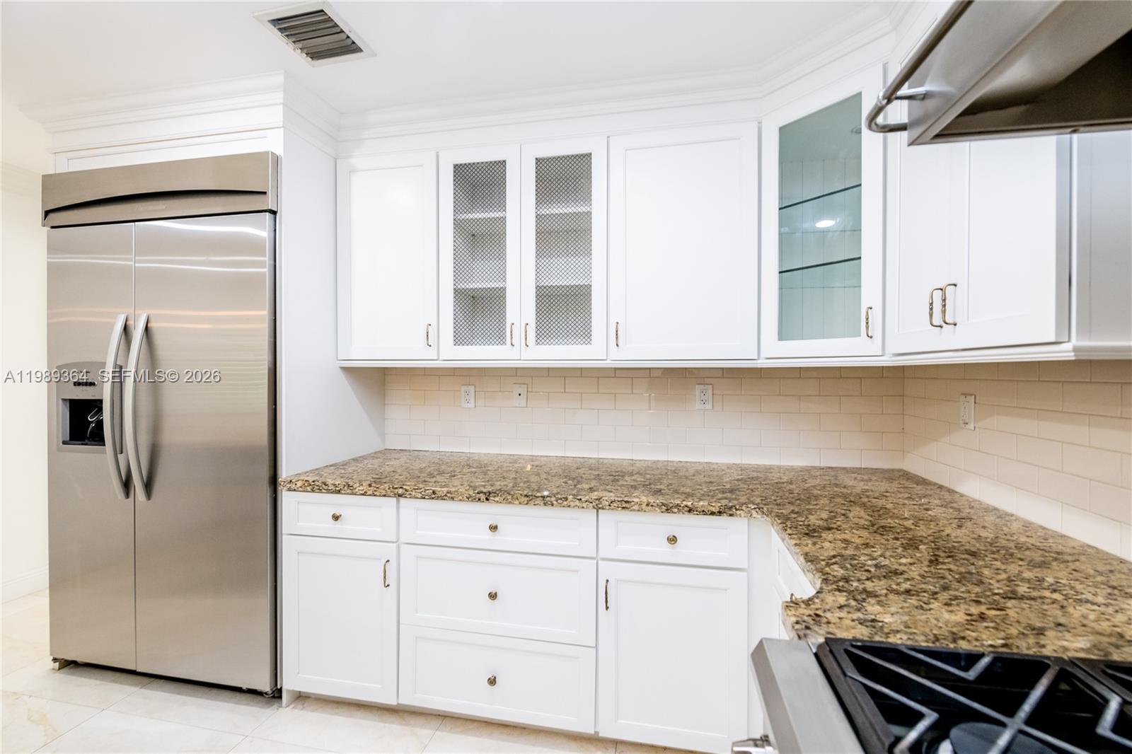 4160 Bay Point Road Miami, FL 33137 - Photo 21 of 60 a kitchen with stainless steel appliances granite countertop a refrigerator and white cabinets
