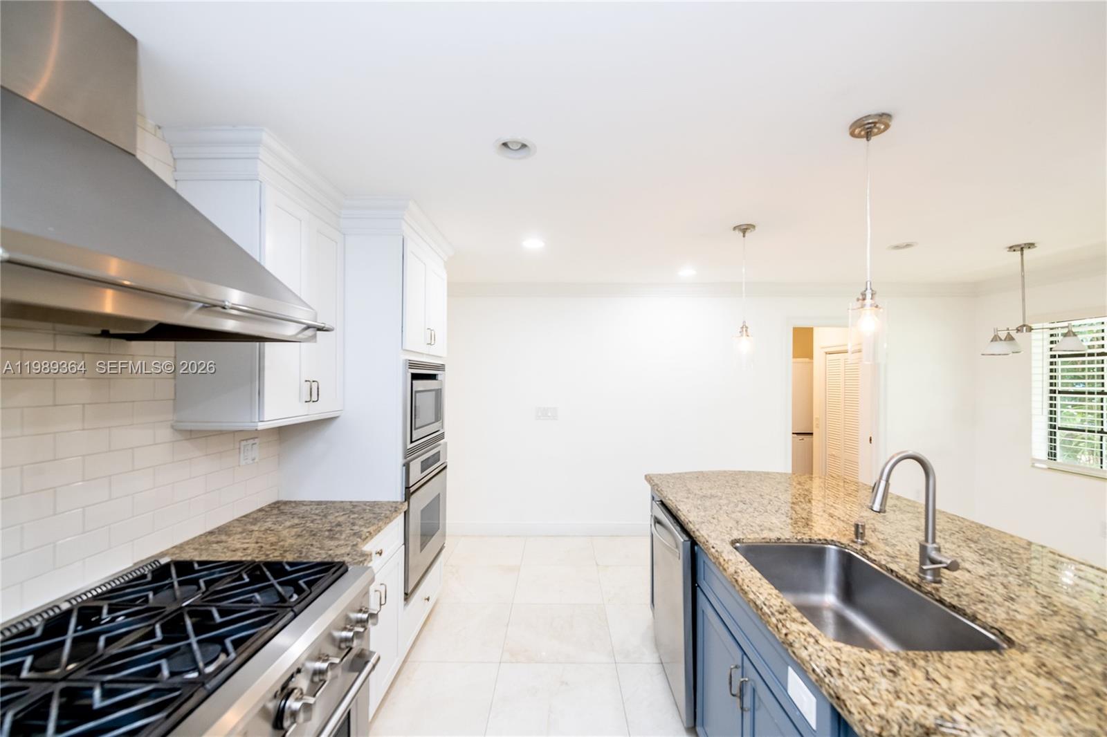 4160 Bay Point Road Miami, FL 33137 - Photo 23 of 60 a kitchen with stainless steel appliances granite countertop a sink stove and refrigerator