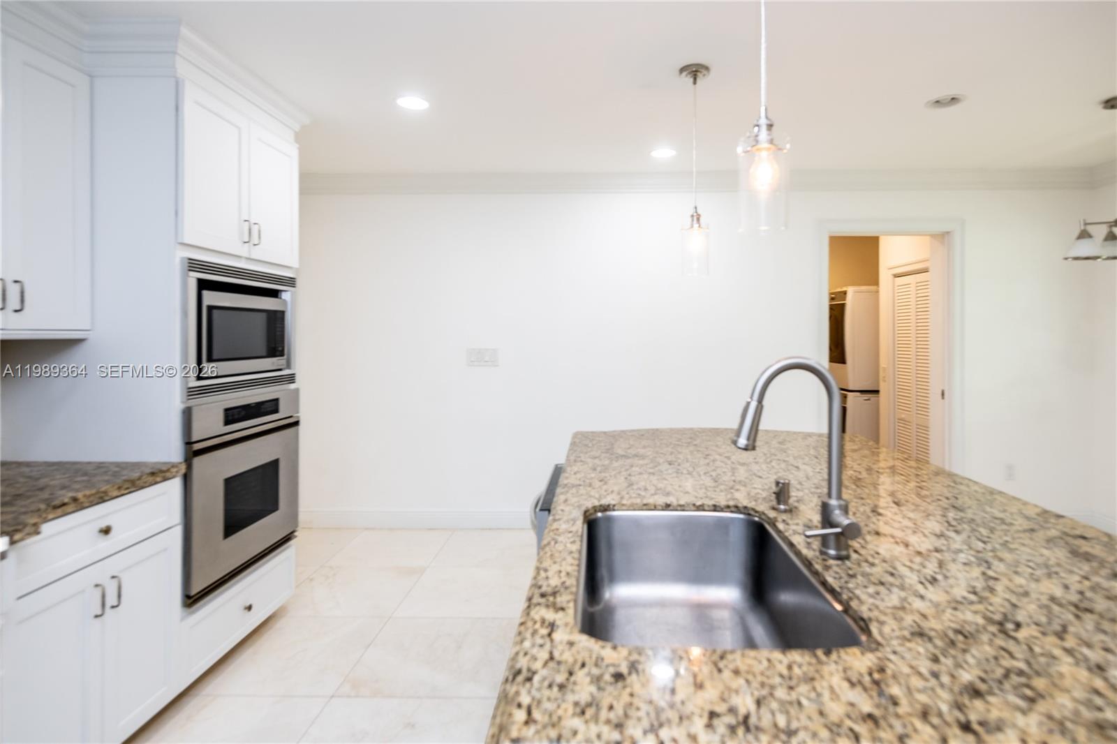 4160 Bay Point Road Miami, FL 33137 - Photo 25 of 60 a kitchen with stainless steel appliances granite countertop a sink a stove and cabinets
