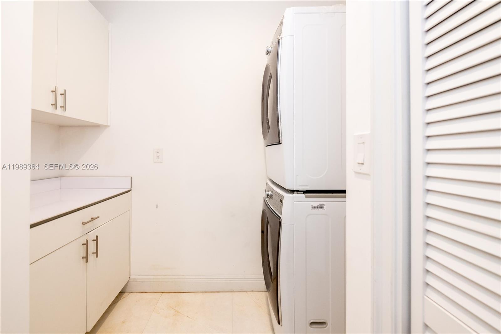 4160 Bay Point Road Miami, FL 33137 - Photo 26 of 60 a utility room with cabinets washer and dryer