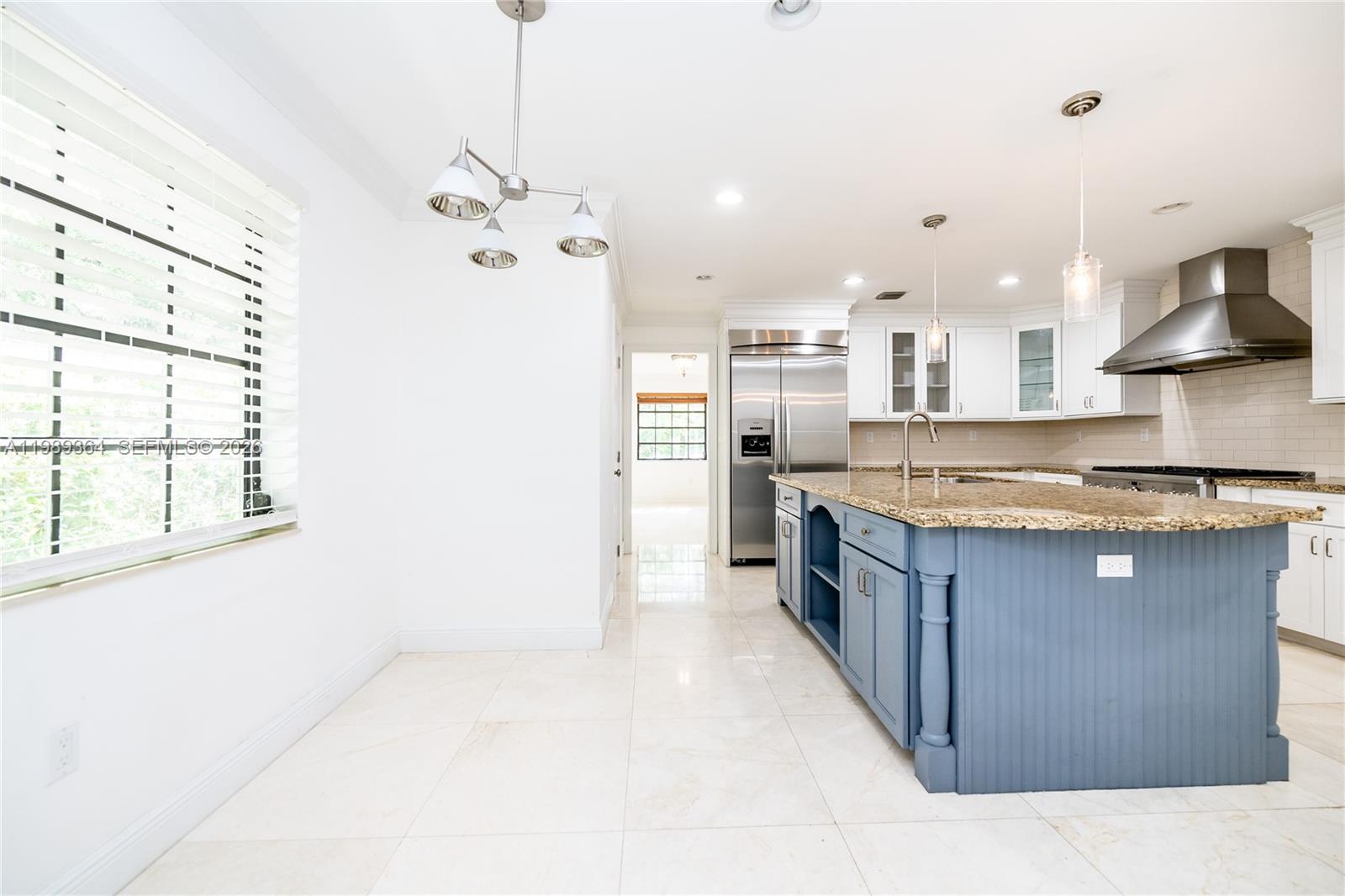 4160 Bay Point Road Miami, FL 33137 - Photo 27 of 60 a kitchen with stainless steel appliances granite countertop a sink a stove and a refrigerator