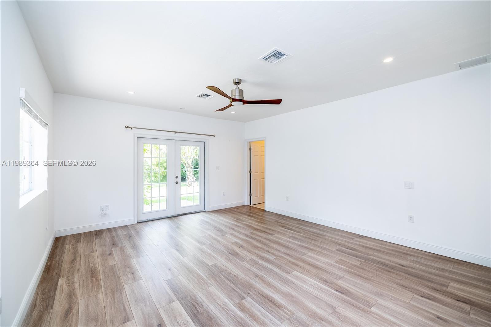 4160 Bay Point Road Miami, FL 33137 - Photo 29 of 60 wooden floor in an empty room with a window