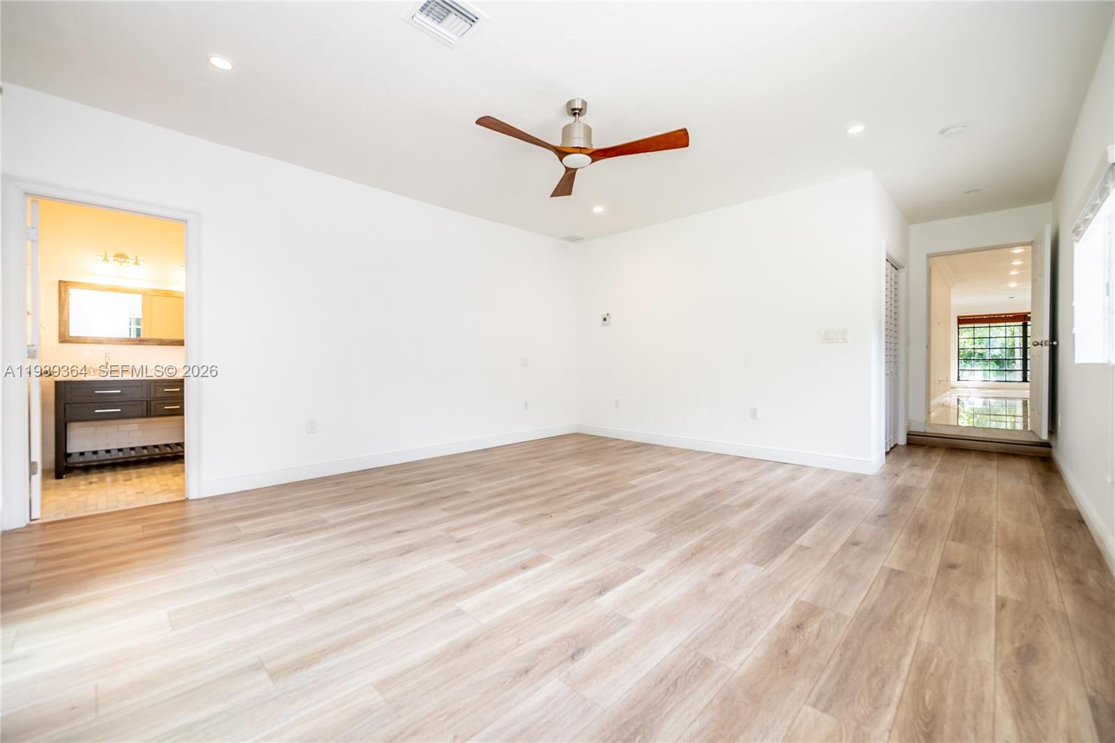 4160 Bay Point Road Miami, FL 33137 - Photo 36 of 60 a view of a room with wooden floor and a ceiling fan