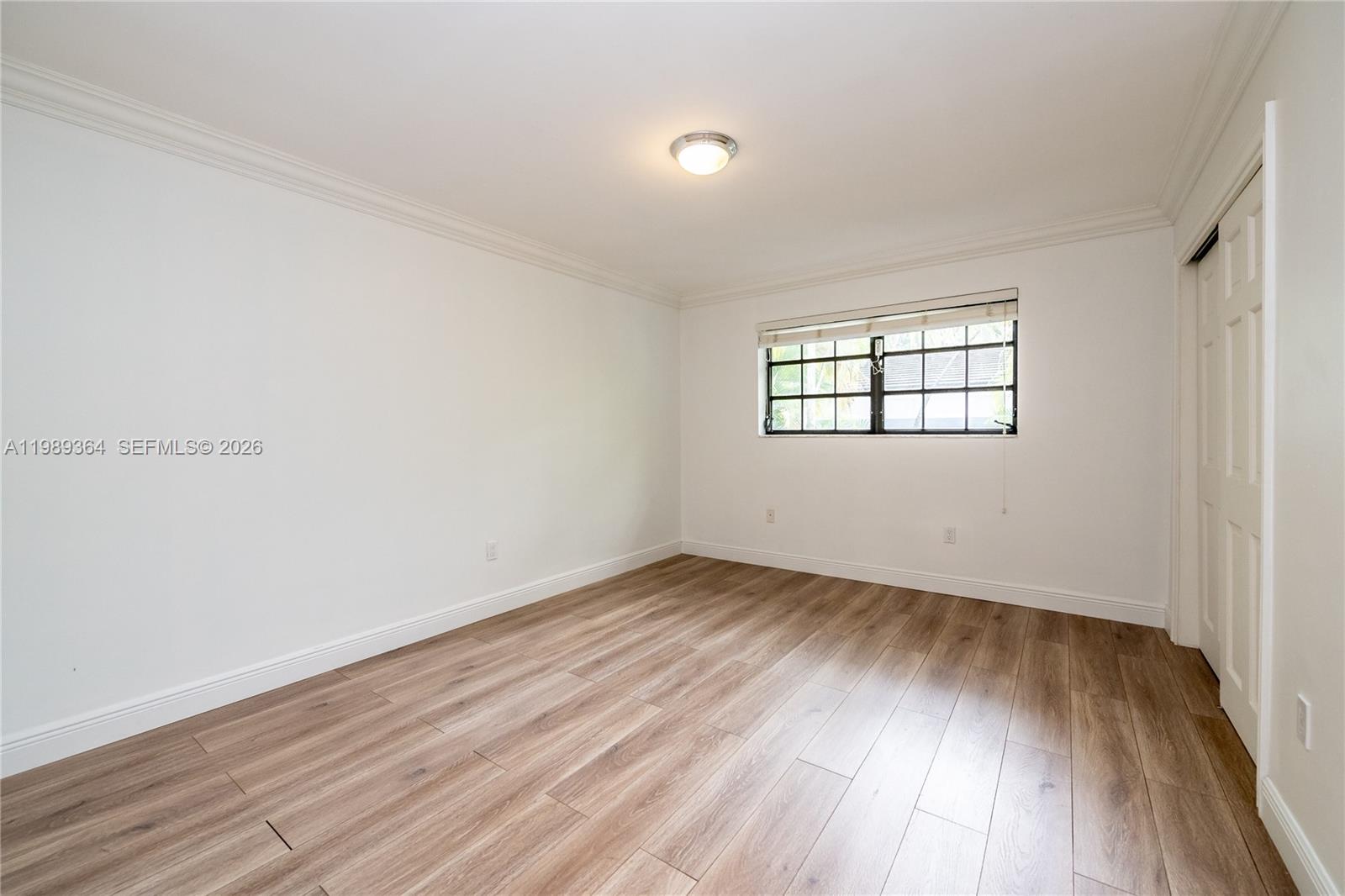 4160 Bay Point Road Miami, FL 33137 - Photo 39 of 60 an empty room with wooden floor and windows