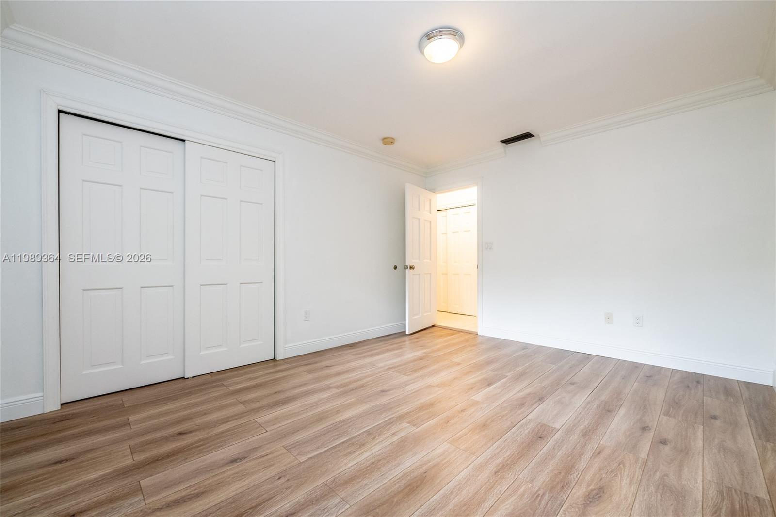 4160 Bay Point Road Miami, FL 33137 - Photo 40 of 60 a view of an empty room with wooden floor