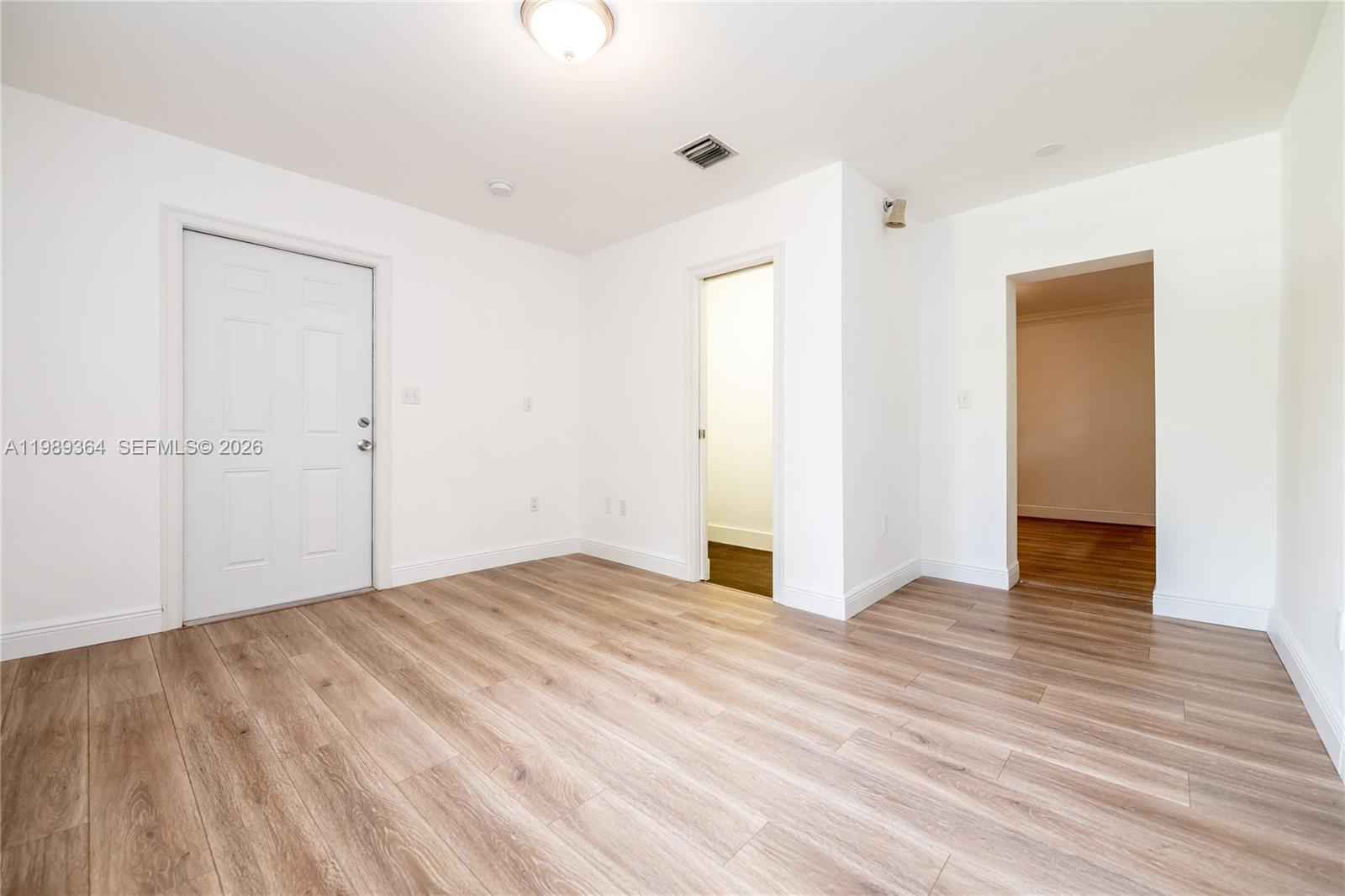 4160 Bay Point Road Miami, FL 33137 - Photo 44 of 60 a view of an empty room with wooden floor