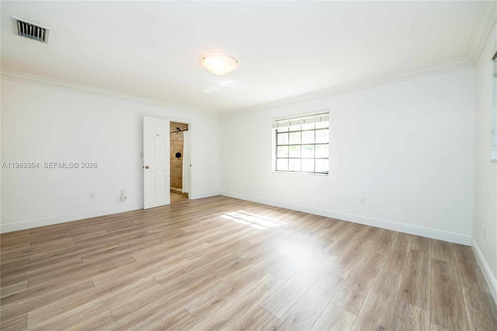 4160 Bay Point Road Miami, FL 33137 - Photo 47 of 60 an empty room with wooden floor and windows
