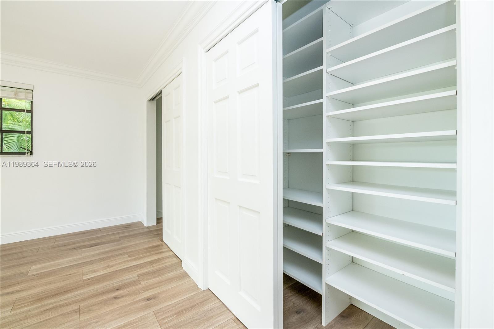 4160 Bay Point Road Miami, FL 33137 - Photo 48 of 60 a view of walk in closet with empty racks
