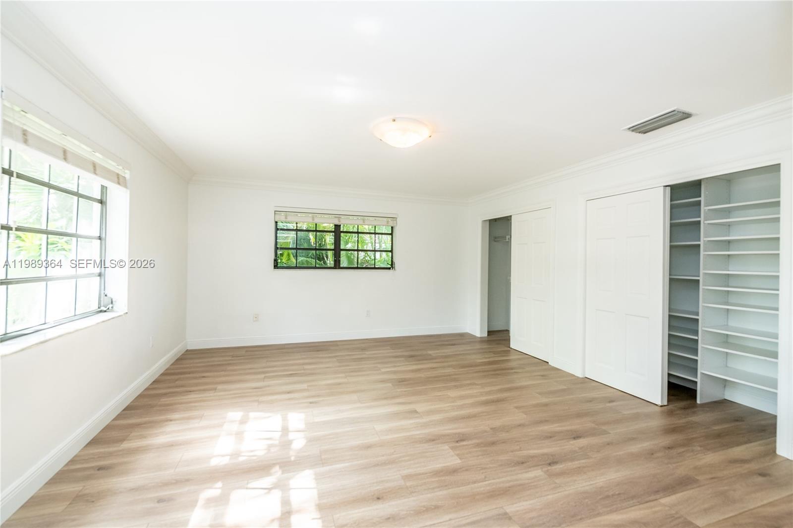 4160 Bay Point Road Miami, FL 33137 - Photo 49 of 60 an empty room with wooden floor and windows