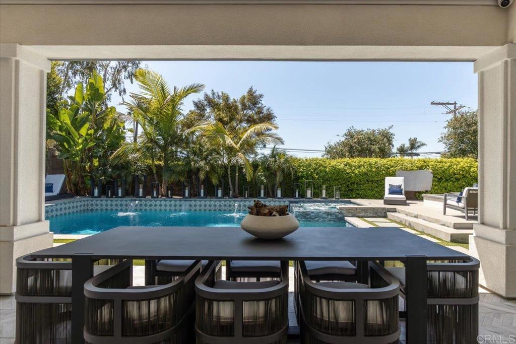 a view of a patio with table and chairs and potted plants