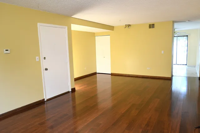 an empty room with wooden floor